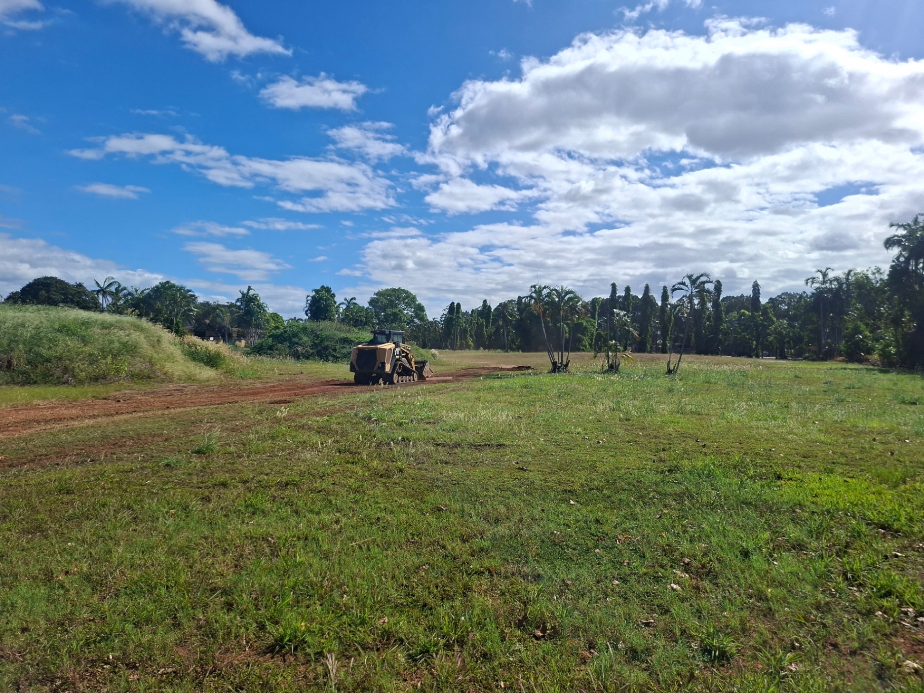 Tracked skid steer working a graded pad during practical machine training