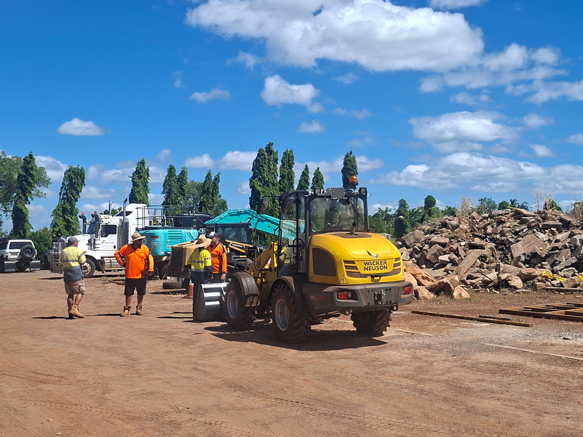 Wacker Neuson wheel loader, excavator and tip truck with crew on a Darwin civil training yard